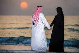 A couple holding hands on beach